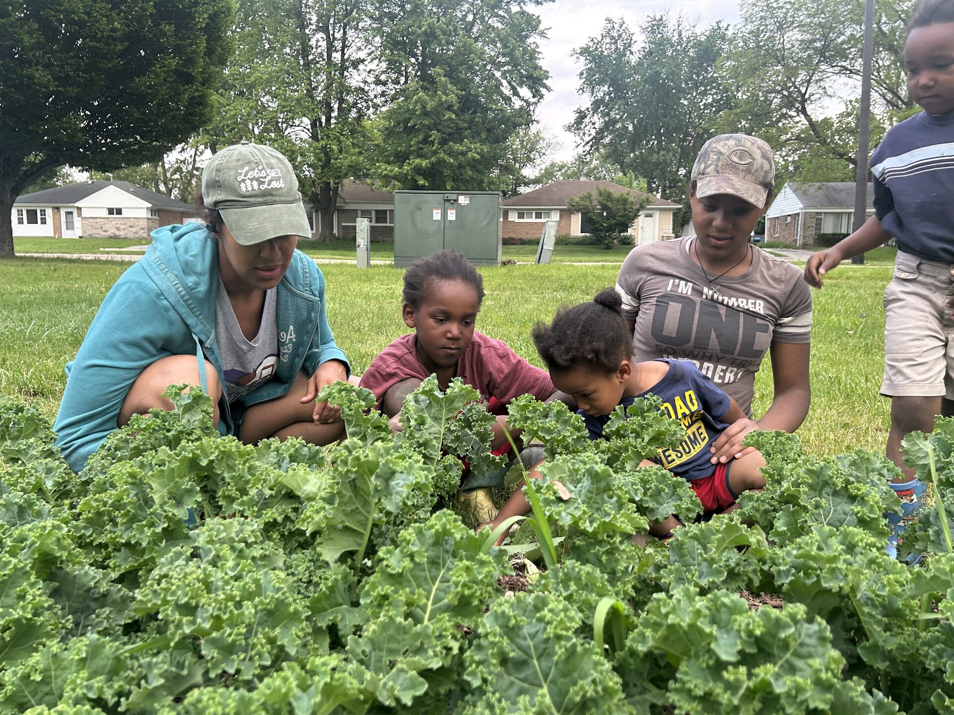 The Obah family teaching children about gardening